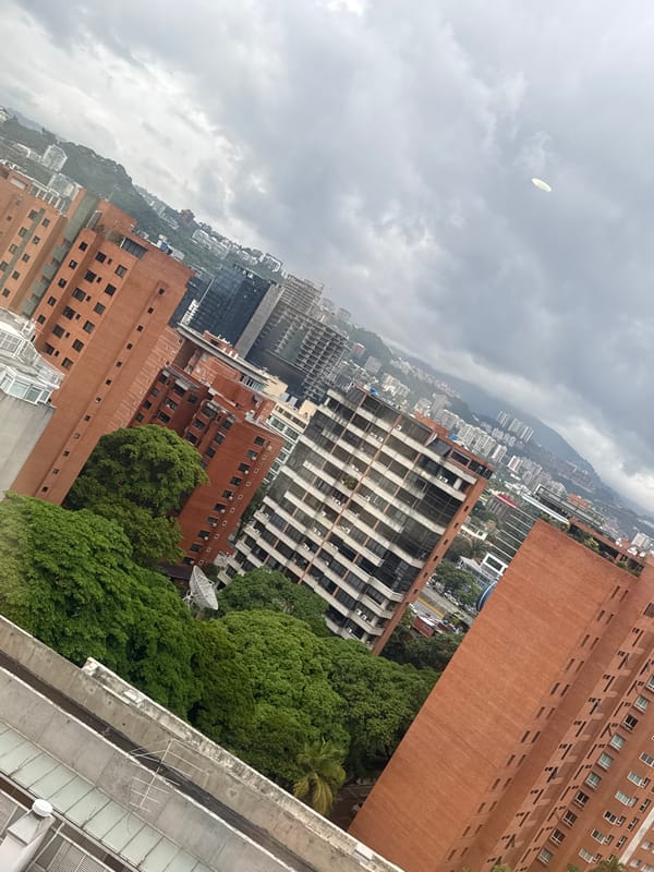 Aerial view captures cloudy day over dense Caracas cityscape