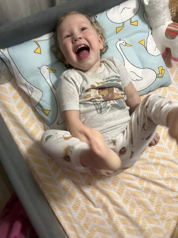 Toddler plays with plush toys on bed in Votkinsk