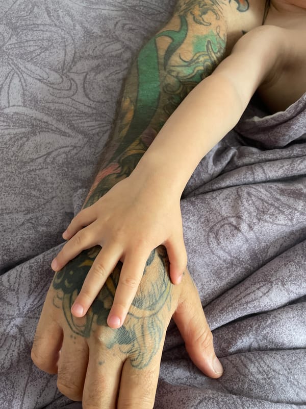 Tattooed adult shares quiet moment with child in Vladivostok