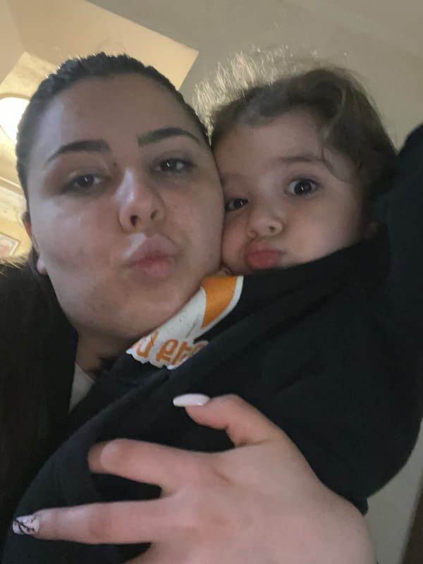 Woman and child share playful selfie moment