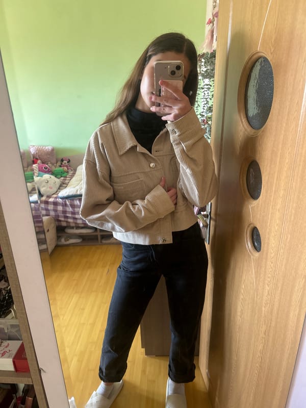 Woman takes mirror selfie in bedroom in Ruse, Bulgaria