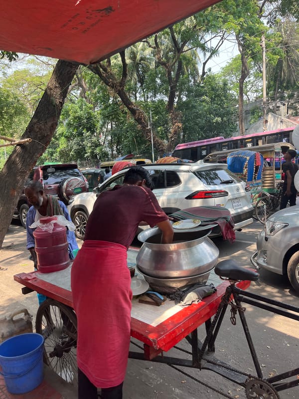 Street food vendor serves meals from bicycle cart in Dhaka