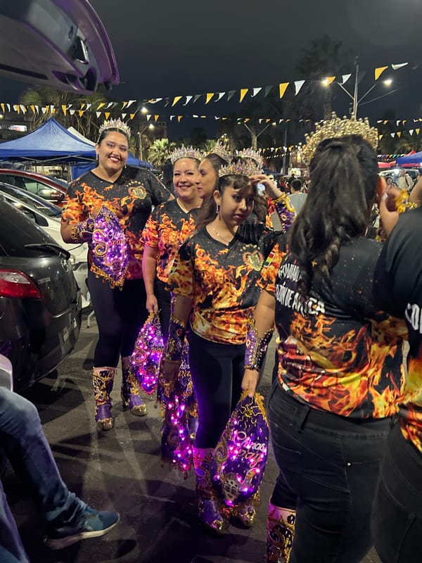 Nighttime street festival with costumed dancers in Arica, Chile
