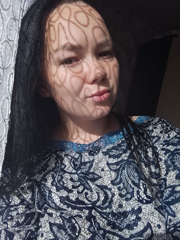 Women photograph moments together indoors in Kuyeda, Russia