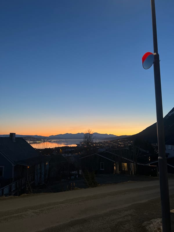 Arctic twilight displays dramatic colors over Tromsø fjord