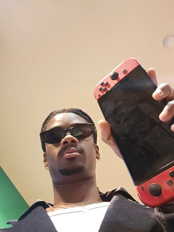 Person with sunglasses holds Nintendo Switch in Paris