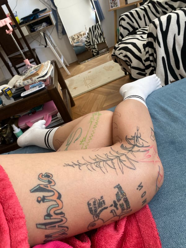 Tbilisi studio morning: sketchbooks, tattoos, and art supplies