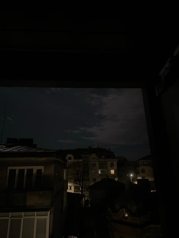 Night view of Ruse apartment buildings from interior