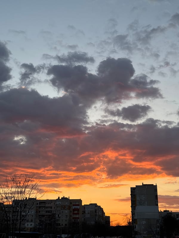 Urban sunset shows dramatic sky contrast between clouds and colors