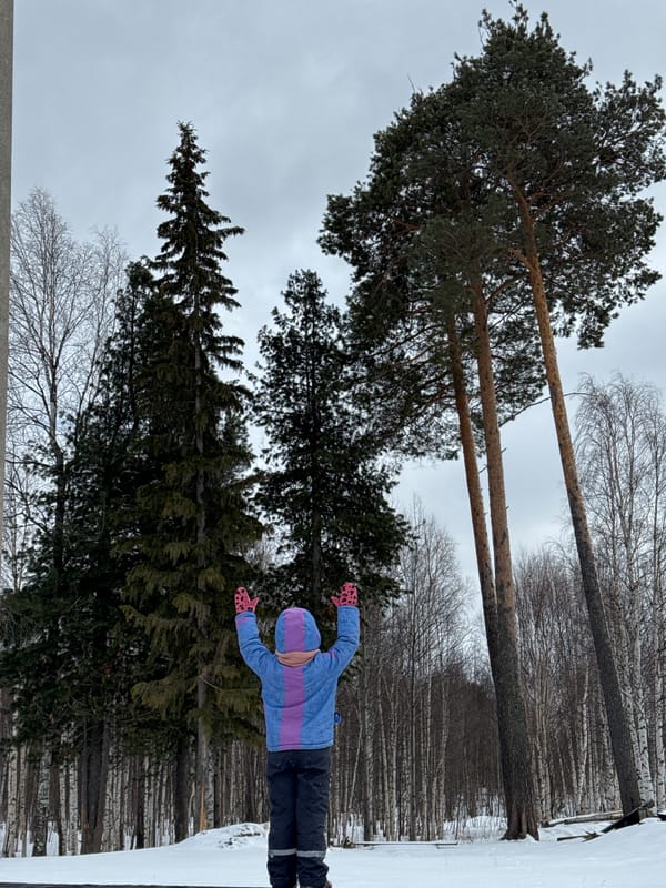 Child plays in snow pile in Russian village