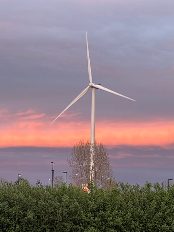 Windmill silhouetted against vibrant sunset in Bruchem, Netherlands