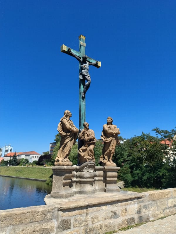Písek's historic Stone Bridge and baroque sculptures on a sunny morning