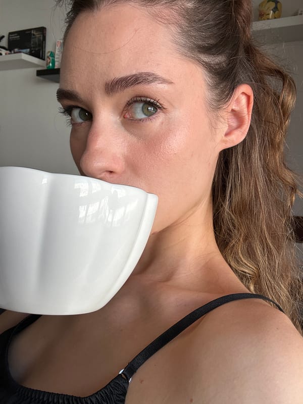 Woman takes morning selfies with coffee mug in Kiel