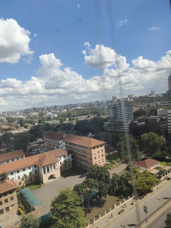 Aerial views document Nairobi cityscape during midday hour