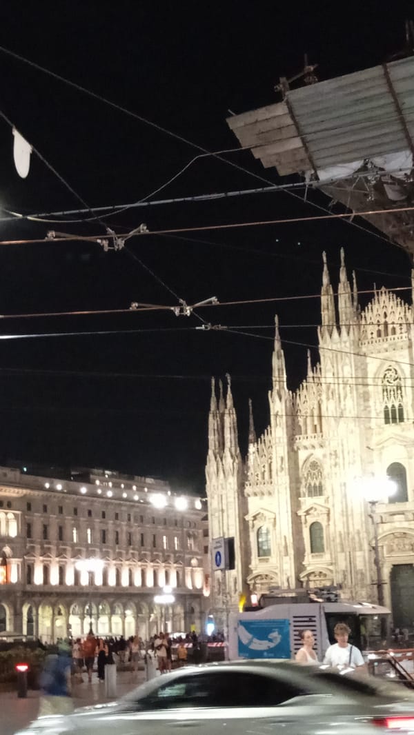 Milan's Duomo district lit up on a summer night