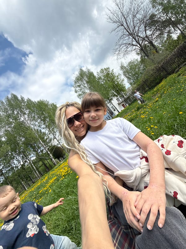 Woman and child share casual outdoor moment in Rusanovo