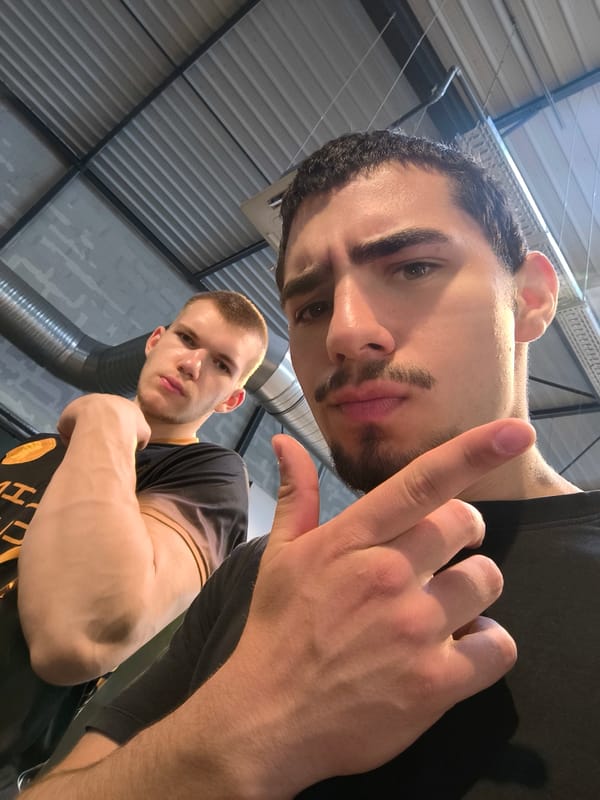 Two men take selfies in industrial space, Hœnheim