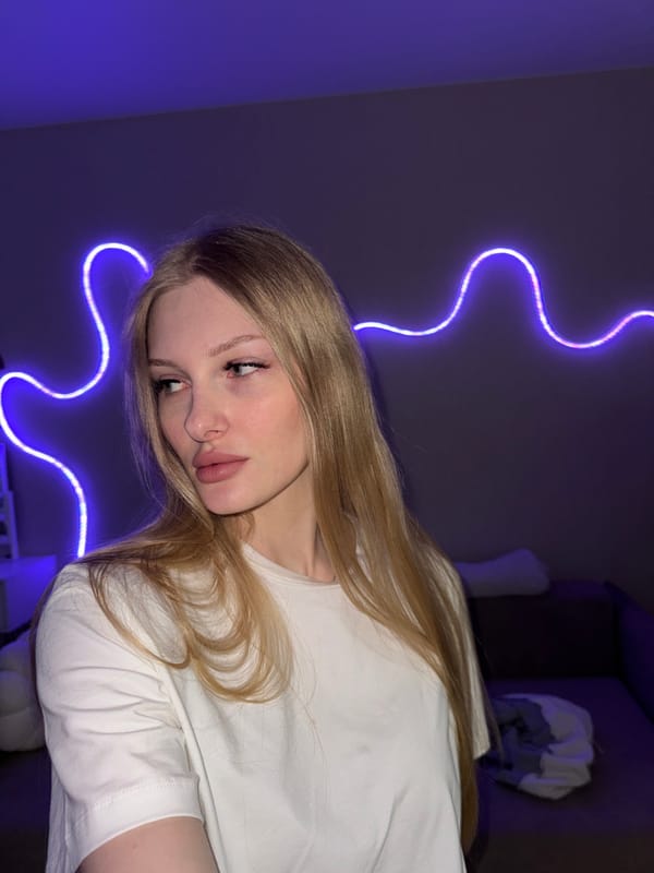 Selfie session in a Perm room with purple neon lighting