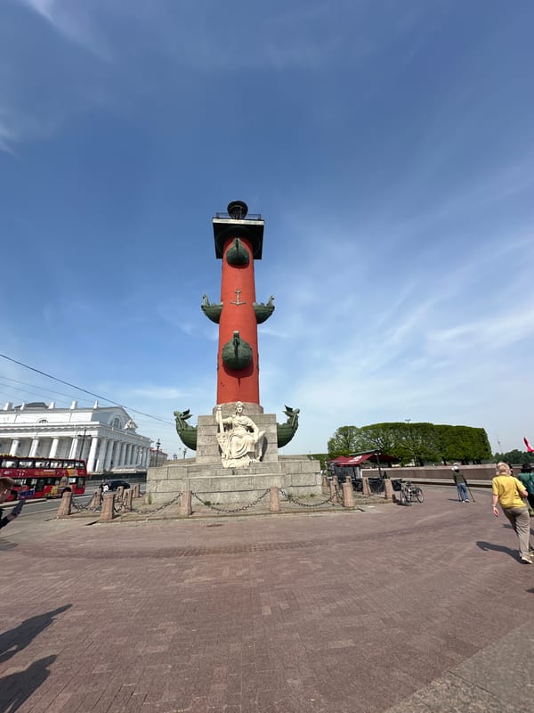 Tourists gather at Saint Petersburg's Rostral Columns on sunny morning