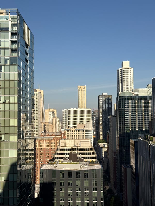Helicopter over Chicago's dense downtown skyline, mid-summer afternoon