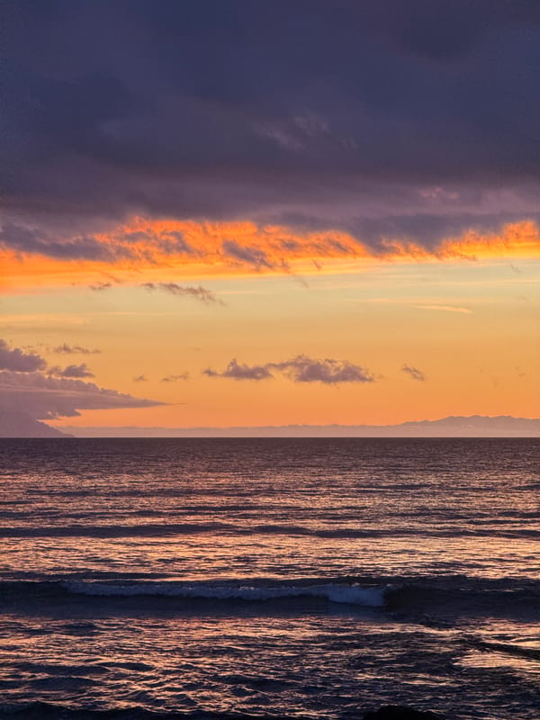 Vivid Atlantic sunset over Arona's rocky coastline