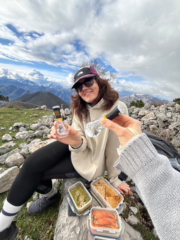 Woman poses at mountainous viewpoint near Baošići, Montenegro