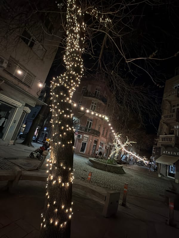 Urban plaza illuminated with string lights captured at night