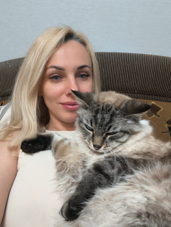 Woman documents quiet afternoon with cats and aquarium in Sevastopol