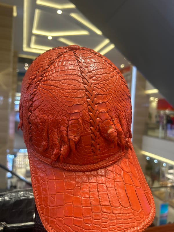Red crocodile-textured baseball cap spotted in Nha Trang