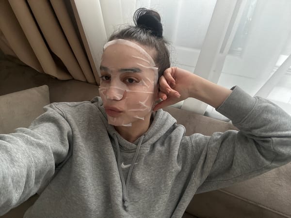 Woman enjoys face mask treatment on couch in Sofia