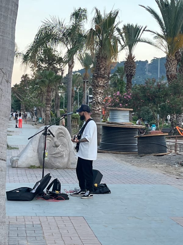 Street musician performs at sunset in Alanya, Turkey