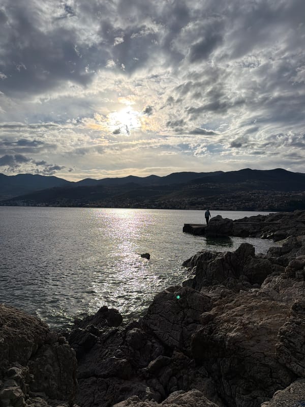 Woman poses on Rijeka waterfront amid coastal scenery