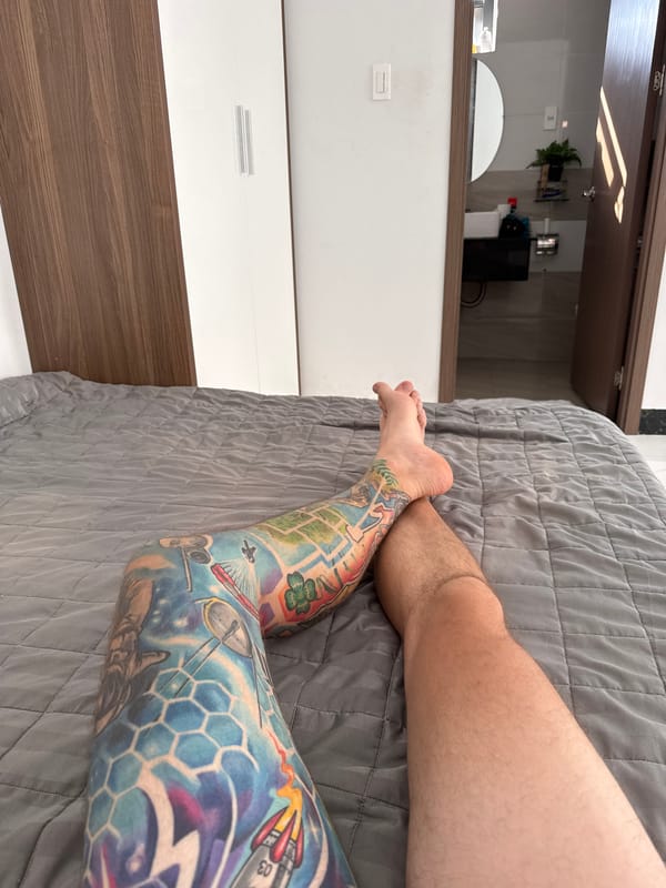 Tattooed leg photographed on bedspread in Vietnam