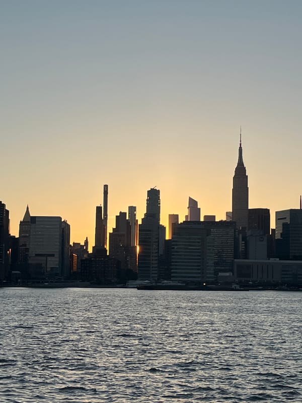 Manhattan skyline glows at sunset from East River waterfront