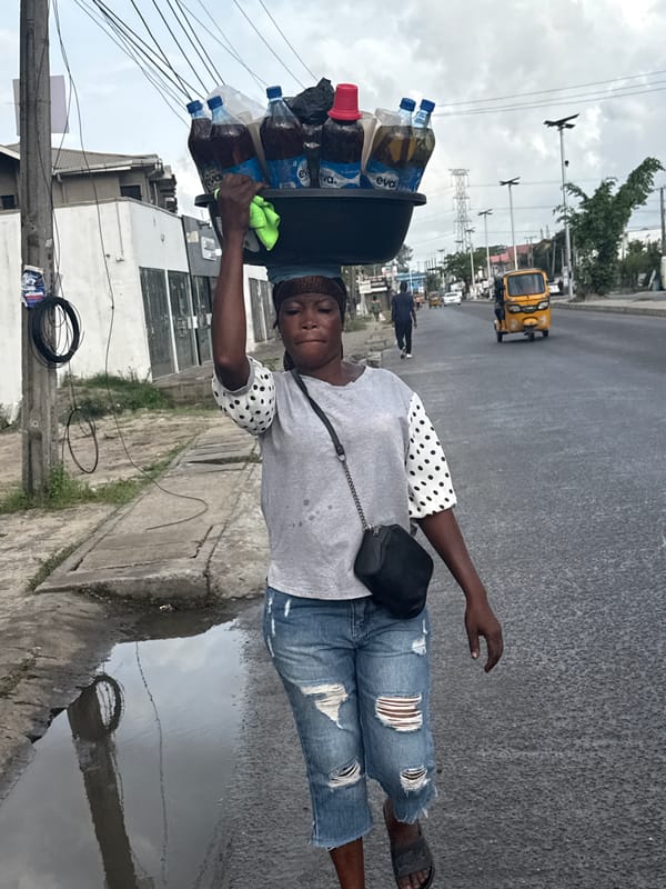 Women walking streets in Ado, Nigeria morning hours