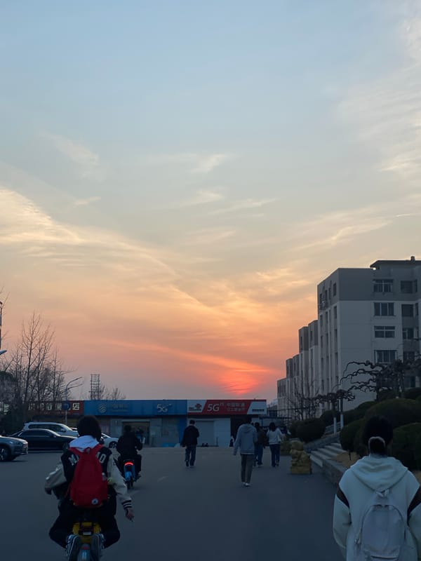 Evening street activity in Zhongtun with pedestrians and cyclists