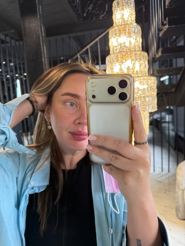Woman takes chandelier selfie with gold iPhone in Moscow