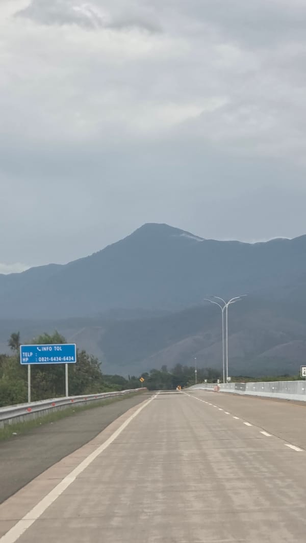 Highway scene documented near mountains in Baksukon, Indonesia