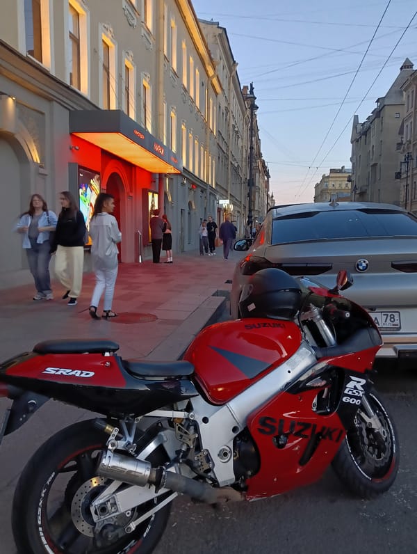 Evening stop in Saint Petersburg, Suzuki parked outside cinema and cafe
