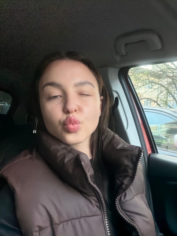 Woman takes playful car selfies in Pernik, Bulgaria