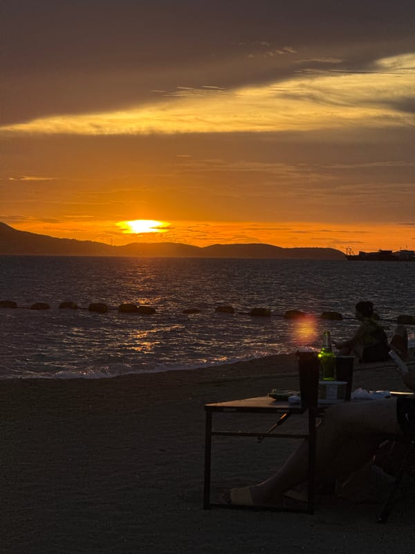 Pattaya beachfront at golden hour, vendors and calm seas