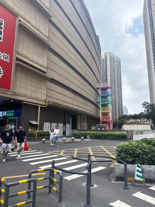 Haizhu District streets buzzing with delivery activity and parked scooters