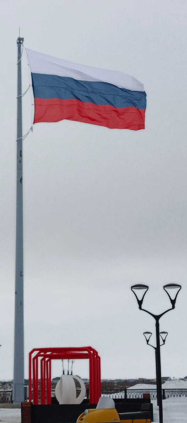 Russian flag flies over snowy Nar'yan-Mar on overcast day