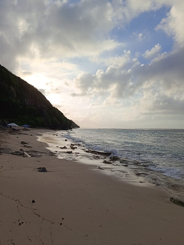 Quiet beach scenes at the water's edge, rocks and surf