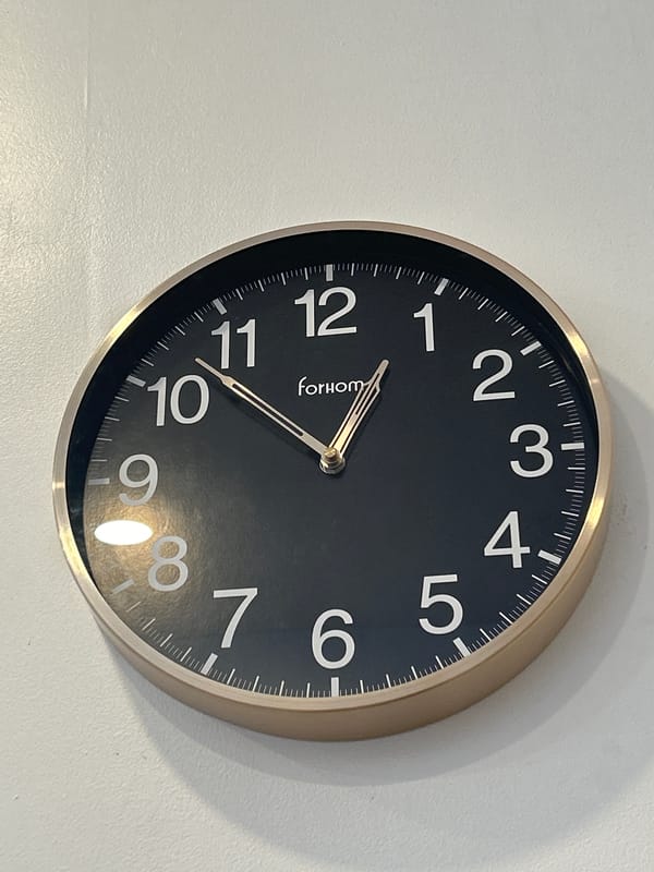 Indoor details: clock, calendar, and shelf in one space