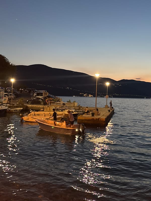 Boats at rest on calm water as dusk settles in