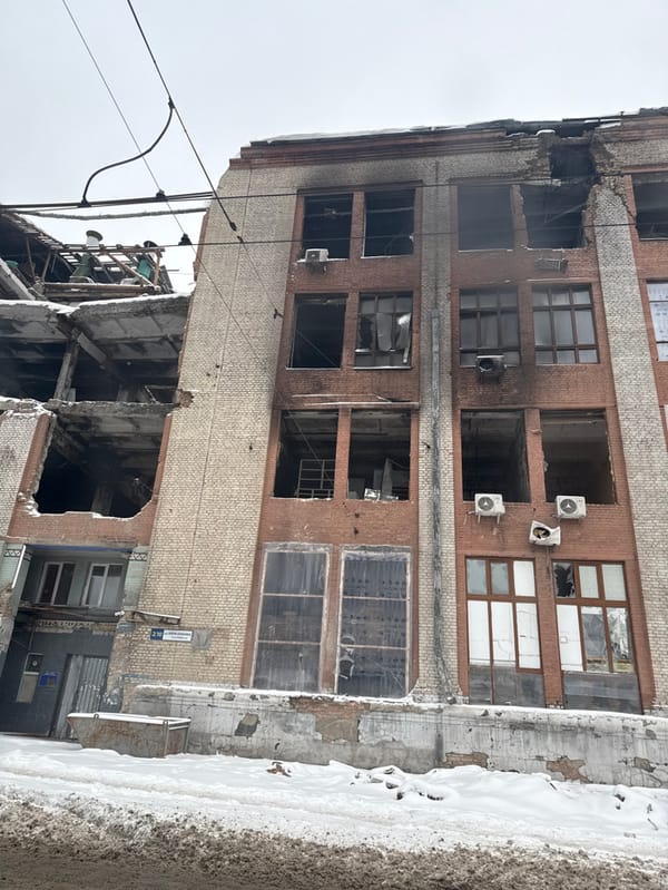 Woman in Toyota near damaged building during winter conditions