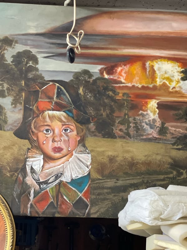 Antique furniture, art, and décor browsed in a cluttered resale setting