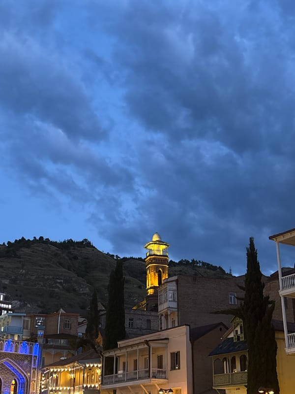Tbilisi Old Town at dusk: sulfur domes, riverside, and lit streets