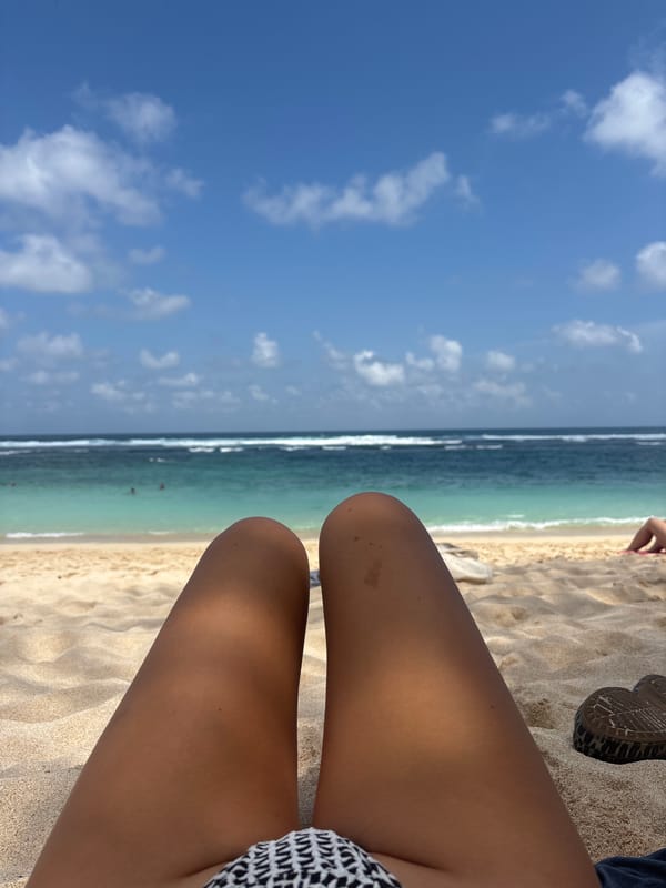 Lazy beach afternoon: sand, sun, and a leopard-print hat